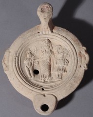 An oil lamp from Egypt, Roman period. It shows Isis and Harpocrates.